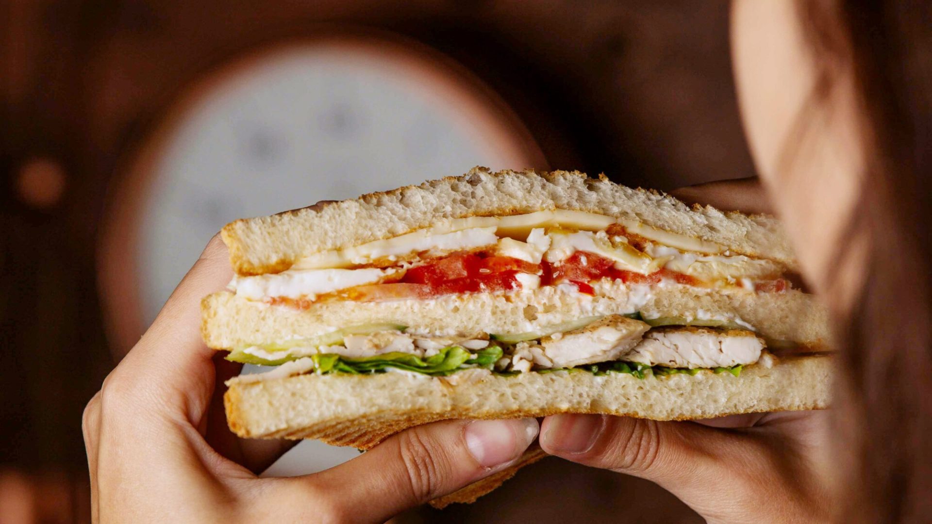 club sandwich in woman hands